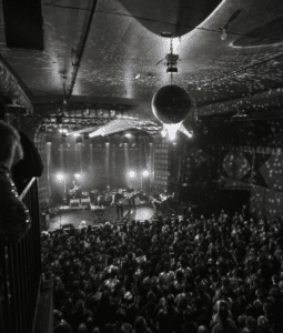 A black and white photo capturing a vibrant crowd at a Los Angeles music venue.