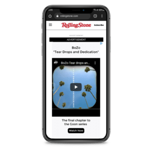 A smartphone screen displaying the rolling stone website with an advertisement for a music track titled "boz*o tears and dedication," along with a play button, part of a series called "the final chapter.