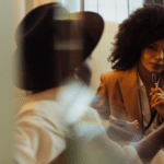 Two women engage in a meeting room conversation.