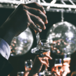 A group of people toasting champagne glasses at a party.