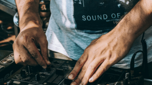 A dj's hands on a dj mixer.