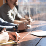 A group of people sitting around a table.