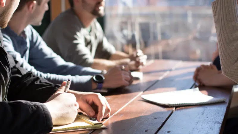 A group of people sitting around a table.