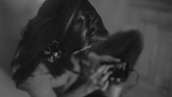 A black and white photo of a woman with headphones.