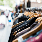 A row of clothes hanging on a rack.