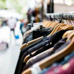 A row of clothes hanging on a rack.