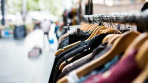 A row of clothes hanging on a rack.