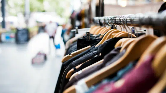 A row of clothes hanging on a rack.