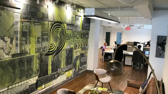 An office with a large mural on the wall.