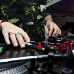 A dj is mixing music at a party.