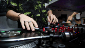 A dj is mixing music at a party.