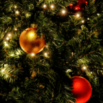 A christmas tree with red and gold ornaments.