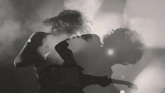 A black and white photo of a man playing a guitar.