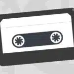 A cassette icon on a gray background.