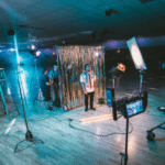 A group of people filming in a gymnasium.