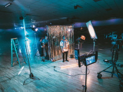 A group of people filming in a gymnasium.