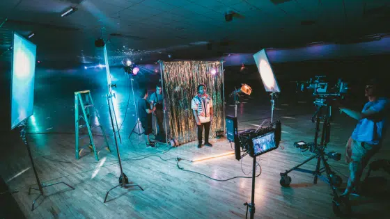 A group of people filming in a gymnasium.