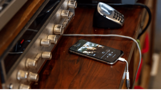 A cell phone is plugged into a stereo.