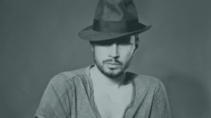 A black and white photo of a man in a hat.