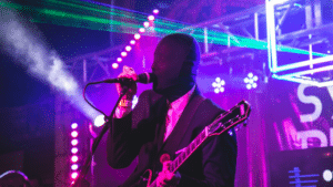 A man in a suit singing into a microphone.