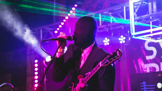 A man in a suit singing into a microphone.