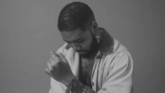 A black and white photo of a man with a beard.