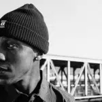 The man is wearing a black beanie.
