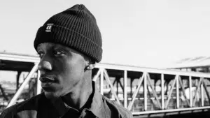 The man is wearing a black beanie.