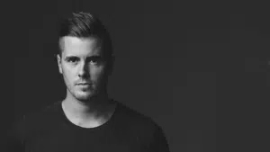A man in a black shirt is posing for a photo.