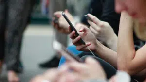 A group of people holding cell phones.