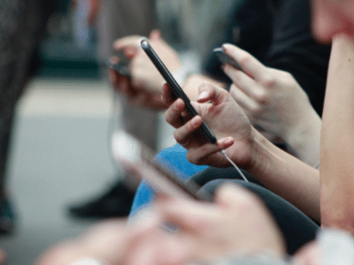 A group of people holding cell phones.