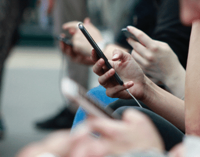 A group of people holding cell phones.