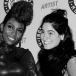 Two women posing for a photo at the international music awards.