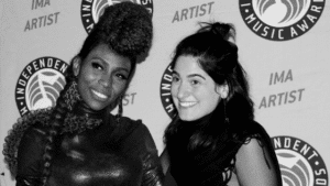 Two women posing for a photo at the international music awards.