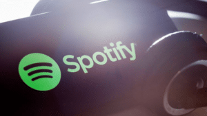 The spotify logo is shown on a pair of headphones.