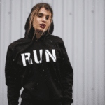A woman wearing a black hoodie with the word run on it.