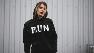 A woman wearing a black hoodie with the word run on it.