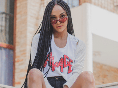 A young woman wearing shorts and a t - shirt.