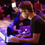 A group of people working on laptops at SXSW.