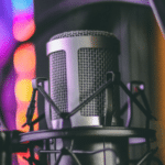 A microphone in front of a colorful background.