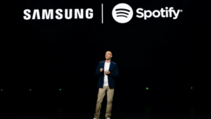 A man standing in front of a samsung spotify logo.