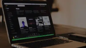 A laptop is sitting on a wooden table.