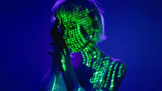 A woman with a green light on her face.