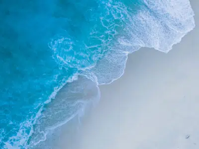 An aerial view of a beach and ocean.