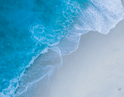 An aerial view of a beach and ocean.