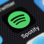 The spotify logo is displayed on an iphone.