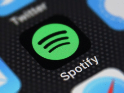 The spotify logo is displayed on an iphone.