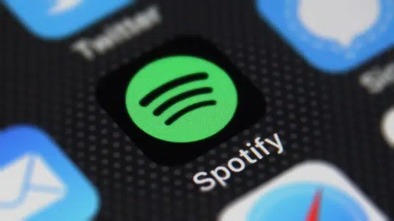 The spotify logo is displayed on an iphone.