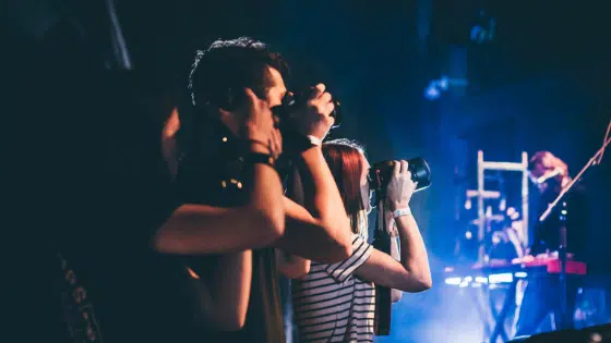 A group of people taking pictures at a concert.