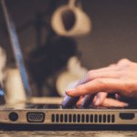 A person typing on a laptop computer.